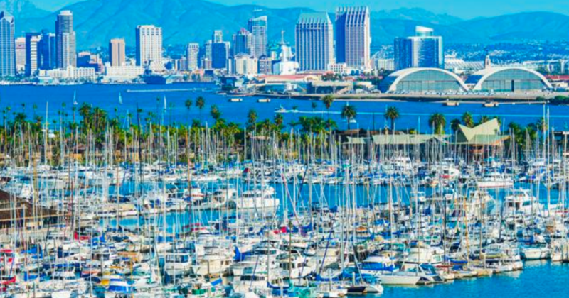 Marina filled with sailboats in the foreground with a view of downtown San Diego across the bay.